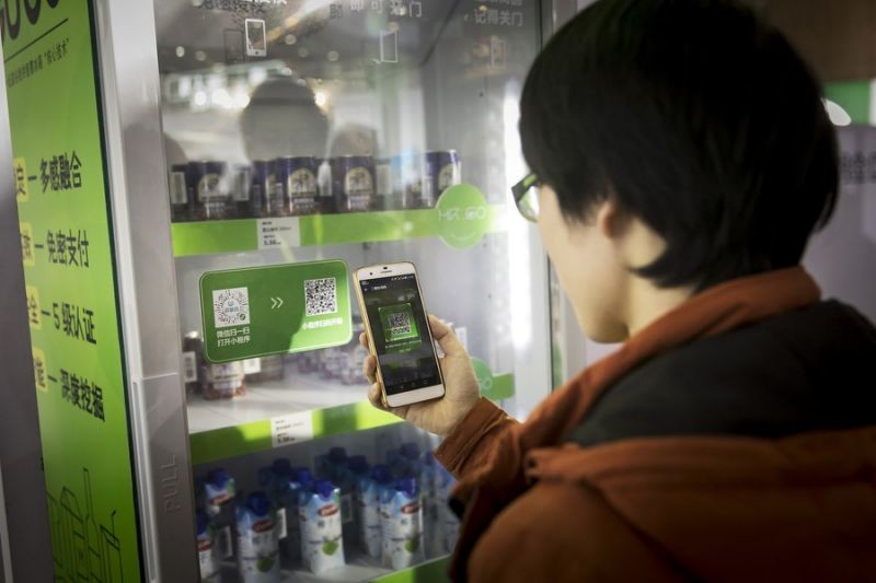 An attendee scans a QR code with his smartphone to purchase a drink from a vending machine at Tencent Holdings Ltd.'s WeChat Open Class Pro conference in Guangzhou, China, on Monday, Jan. 15, 2018. WeChat, the social network that is nearly ubiquitous in China, said at the conference that it has An attendee scans a QR code with his smartphone to purchase a drink from a vending machine at Tencent Holdings Ltd.'s WeChat Open Class Pro conference in Guangzhou, China, on Monday, Jan. 15, 2018. WeChat, the social network that is nearly ubiquitous in China, said at the conference that it has